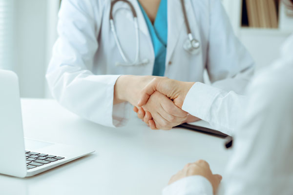 Doctor shaking hands with patient